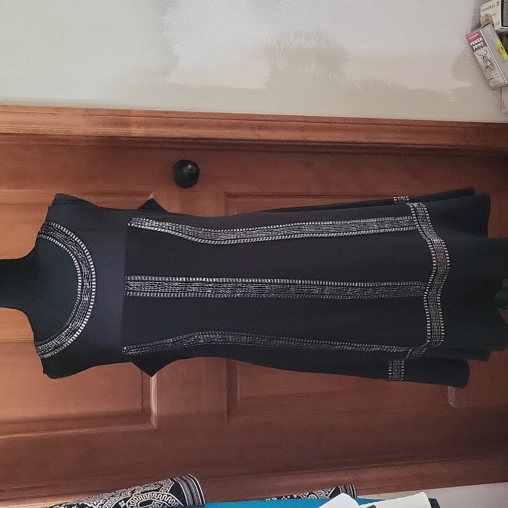 Black dress with sheer top and silver thread design along neck,front,bottom.